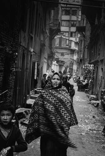 urban grayscale photo of woman wearing hijab headdress black-and-white
