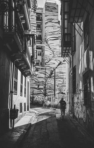 city grayscale photography of person walking black-and-white