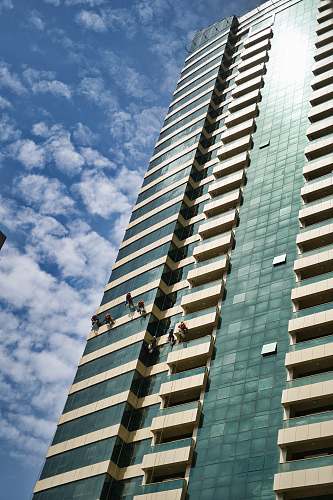 city grey curtain building during daytime high rise