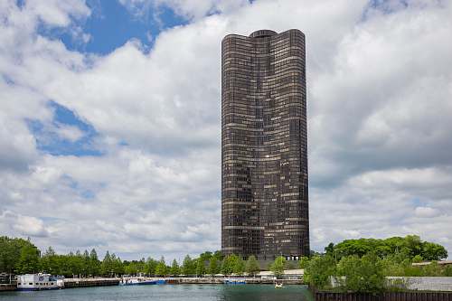 city grey high-rise building near body of water during daytime high rise