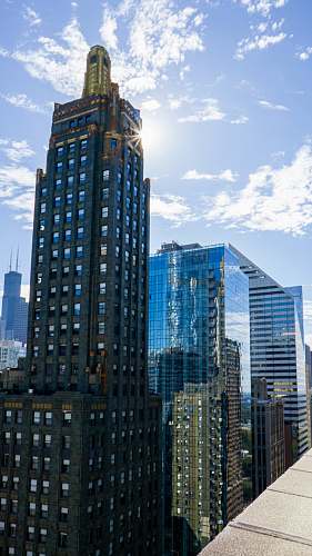 city high-rise building under cloudy sky high rise