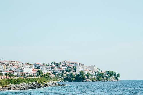 city high rise buildings near cliff ocean