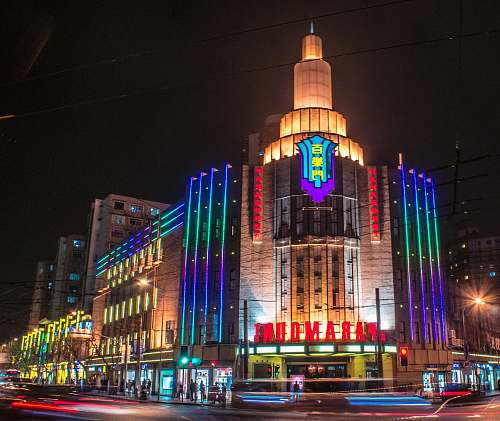 city lighted concrete high-rise building downtown