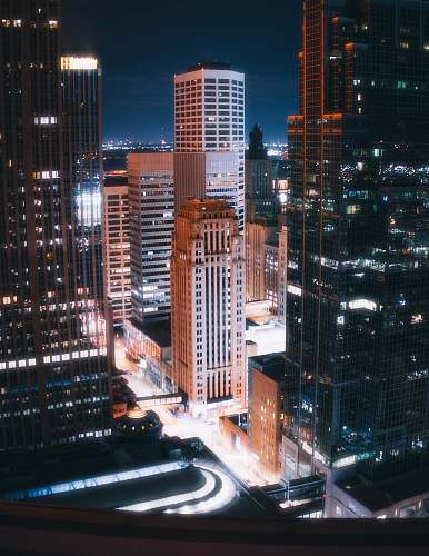 city lighted high-rise buildings at night urban