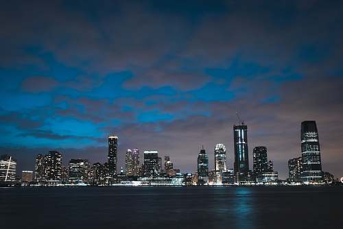 city lighted high rise buildings at nighttime urban