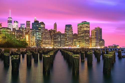 city lighted high-rise buildings under purple sky town