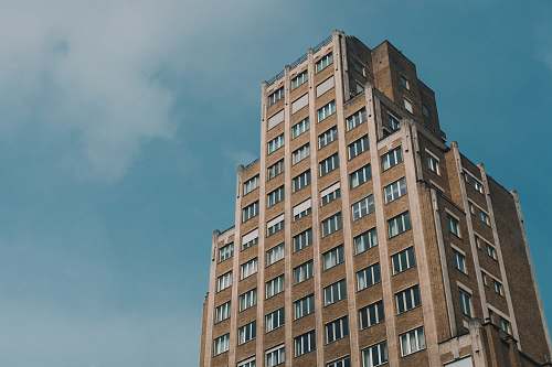 city low-angle photo of brown high-rise building during day time high rise