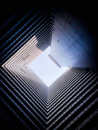 city low angle photo of high rise building during daytime high rise