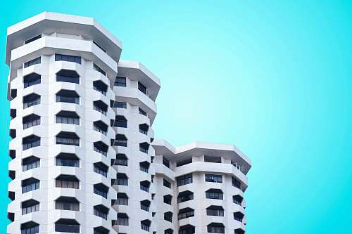 condo low angle photo of white concrete building housing