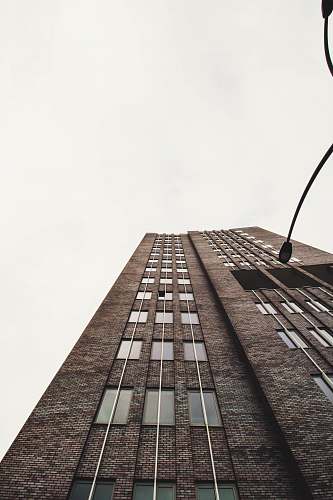 city low-angle photography of brown concrete building high rise