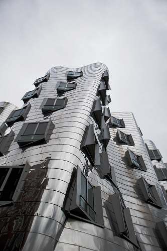 city low-angle photography of building facade black-and-white