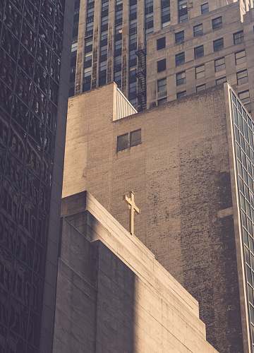 city low angle photography of concrete building with cross urban