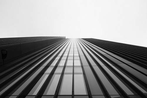 black-and-white low angle photography of curtain wall building office building