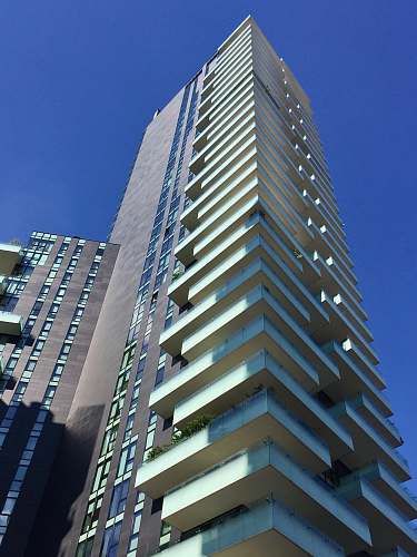 condo low-angle photography of gray high-rise building during daytime housing