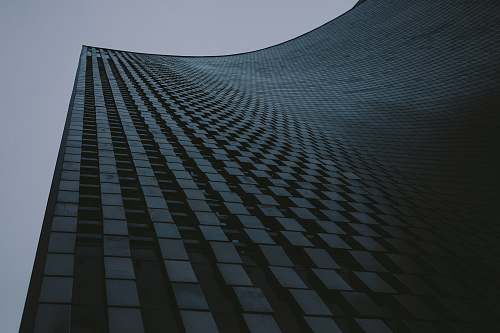city low-angle photography of high-rise building under gray sky architecture