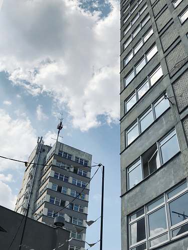 city low-angle photography of high-rise buildings under cloudy sky high rise