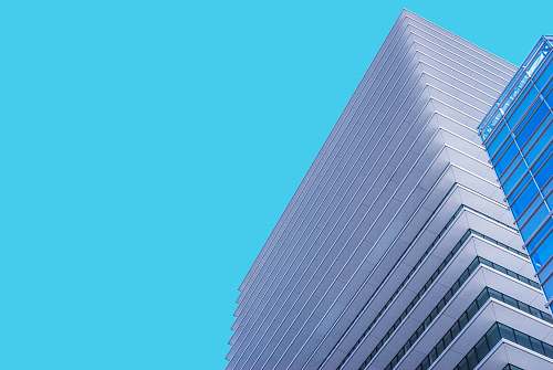 skyscraper low angle photography of white painted building architecture