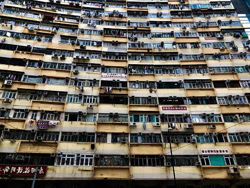 city low-angle photography of yellow concrete building high rise