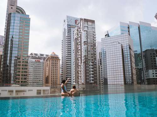 city man and woman in pool high rise