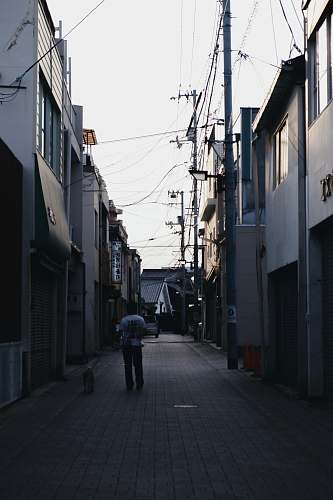 city man standing between alley road
