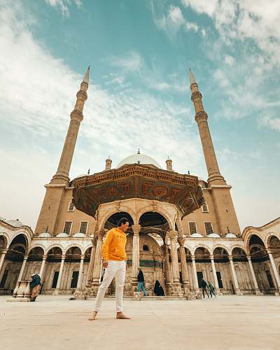 city man standing near mosque downtown