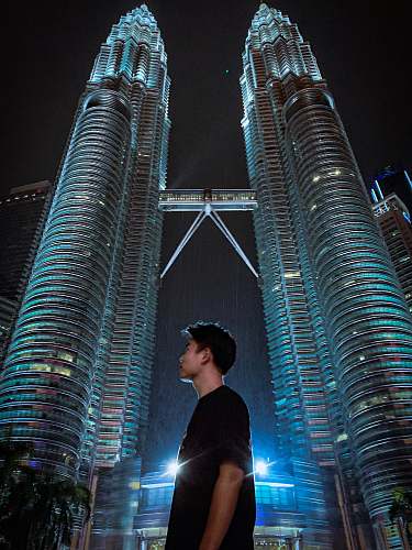 city man standing near Petronas Tower high rise