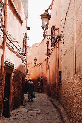 city man standing on pathway beside building road