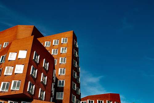 urban mid-rise brown building under blue sky during daytime town