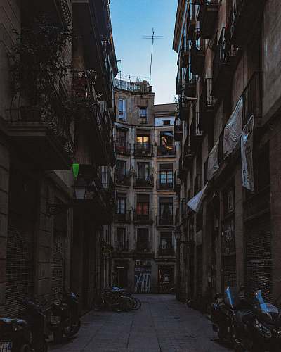 city motorcycles between buildings street