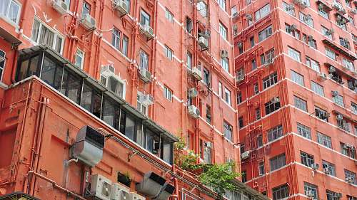 city orange walled building during daytime high rise