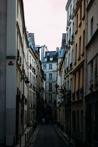 city people at the alley between buildings road