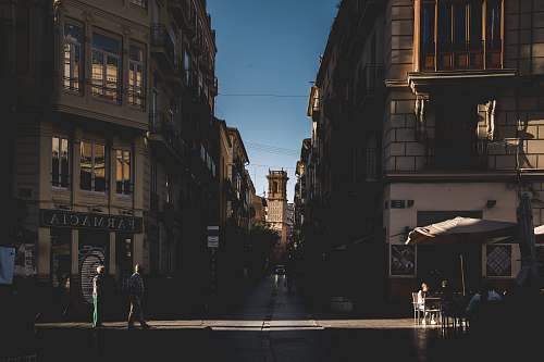 city people beside building road
