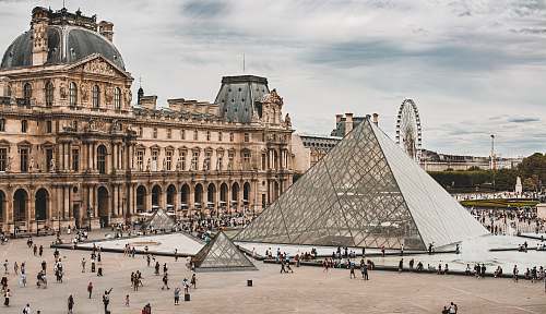 city people gathering near Louvre Museum during daytime downtown