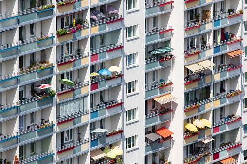 city people in white and multicolored high-rise building high rise