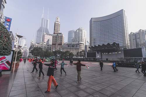 city people on park near buildings downtown