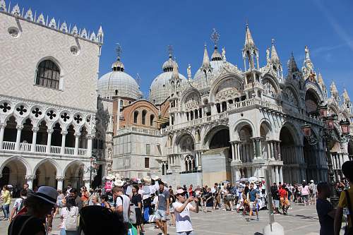 city people standing and walking beside cathedral downtown