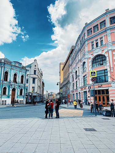 city people standing near open field during daytime downtown