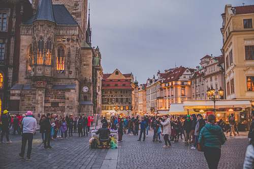 city people surrounded by concrete houses downtown