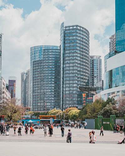 city people walking near buildings during daytime downtown