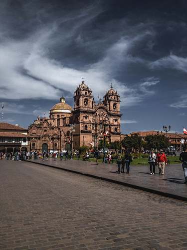 city people walking near cathedral at daytime downtown