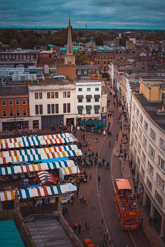 city people walking near stalls downtown