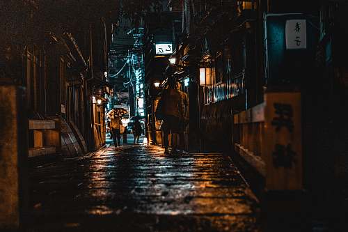 city people walking on alley at night road