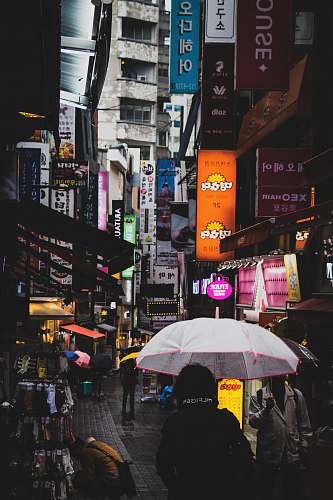 city people walking on pathway holding umbrella metropolis