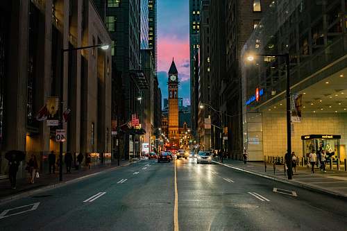 city people walking on sidewalk during night time road