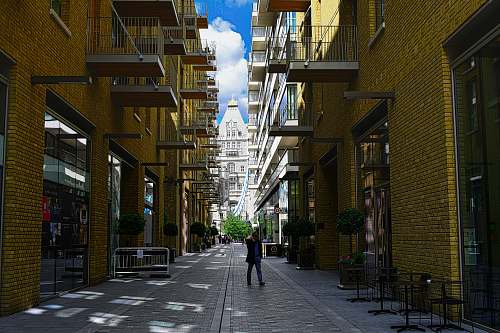street person standing between buildings town