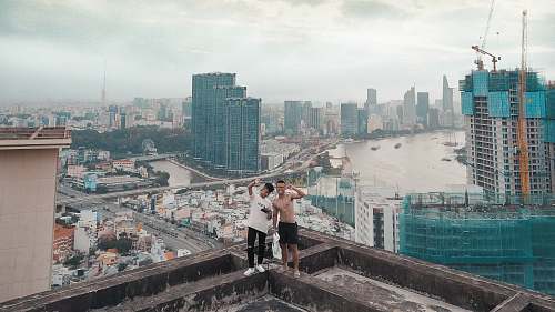 human person standing on top of building during daytime person