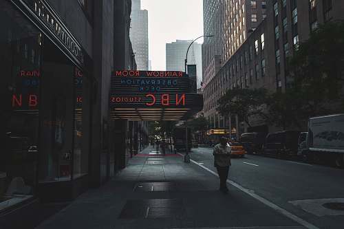 city person walking on sidewalk road