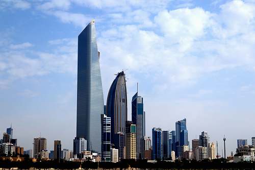 city photography of buildings under blue sky high rise