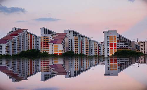 city reflection photography of three buildings high rise