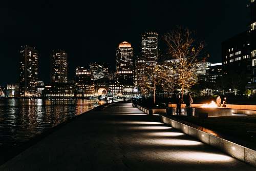 city road beside body of water urban